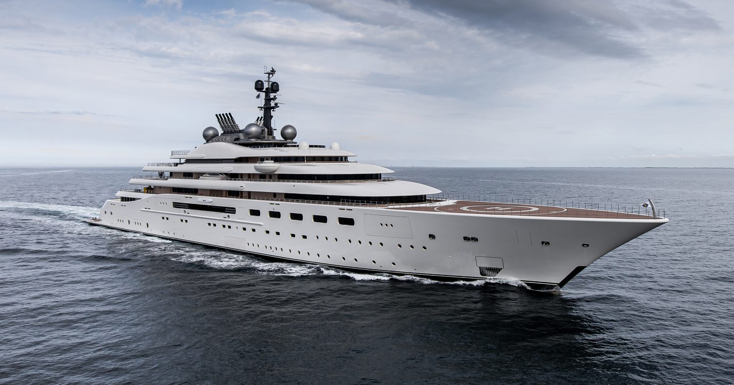 Lurssen superyacht BLUE underway, surrounded by sea on an overcast day.