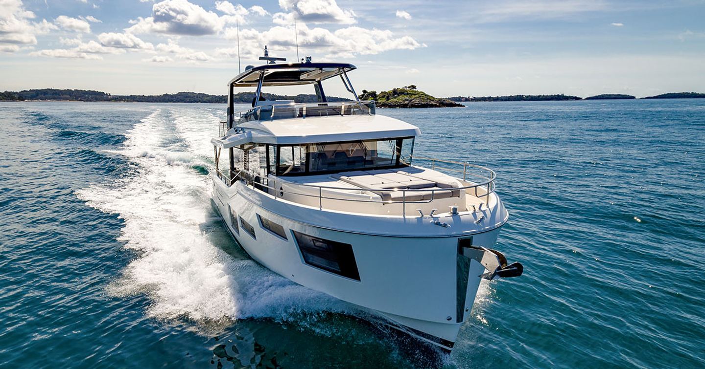 Beneteau Grand Trawler 63 motor yacht underway at speed bow view