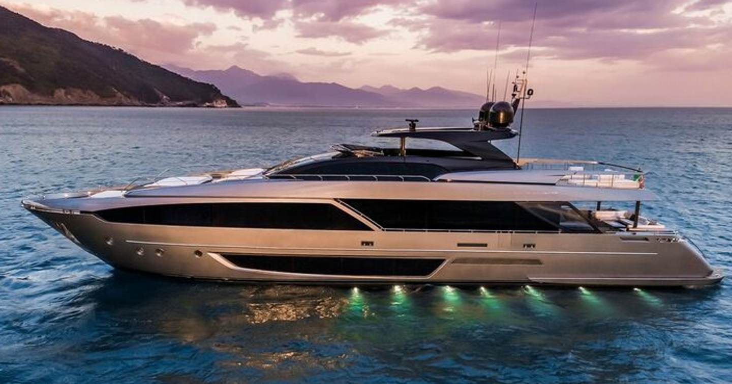 Riva motor yacht Riva Royale at anchor with underwater lights 