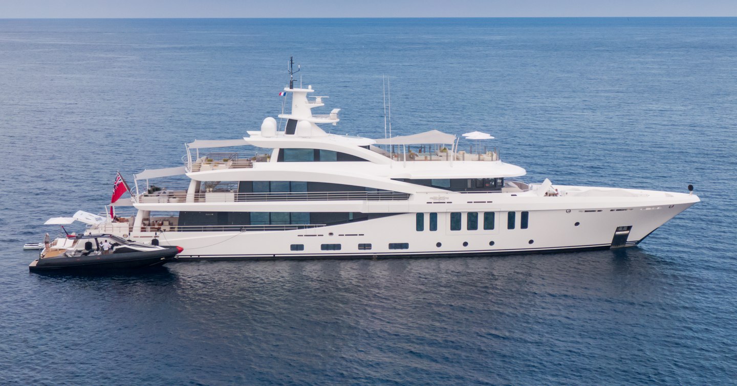 Superyacht Moonstone at anchor with tender adjacent 