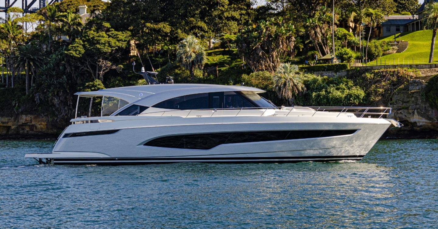 Riviera 6200 yacht at anchor side view