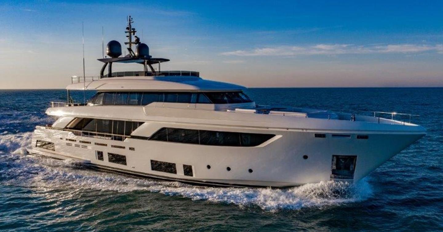 A running shot of EROS, a custom line superyacht showing its extensive glazing on the starboard side