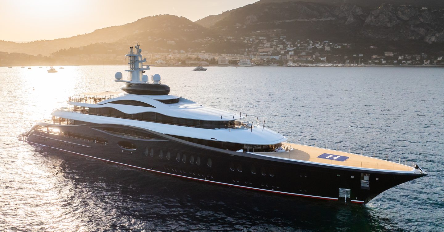 Superyacht LAUNCHPAD at anchor as the sun sets in the background