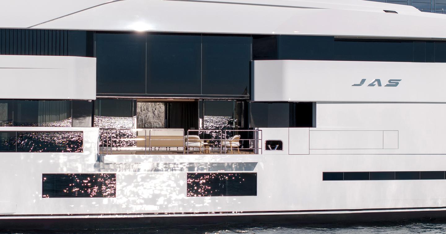 A close-up showing the full-height, sliding glass doors and fold-down balconies onboard superyacht JAS