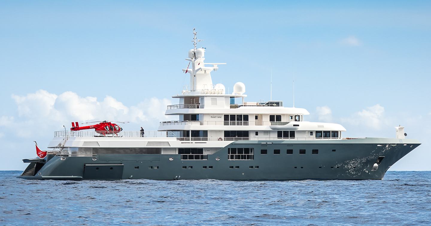 The PLANET NINE explorer yacht features a red helicopter on its helipad