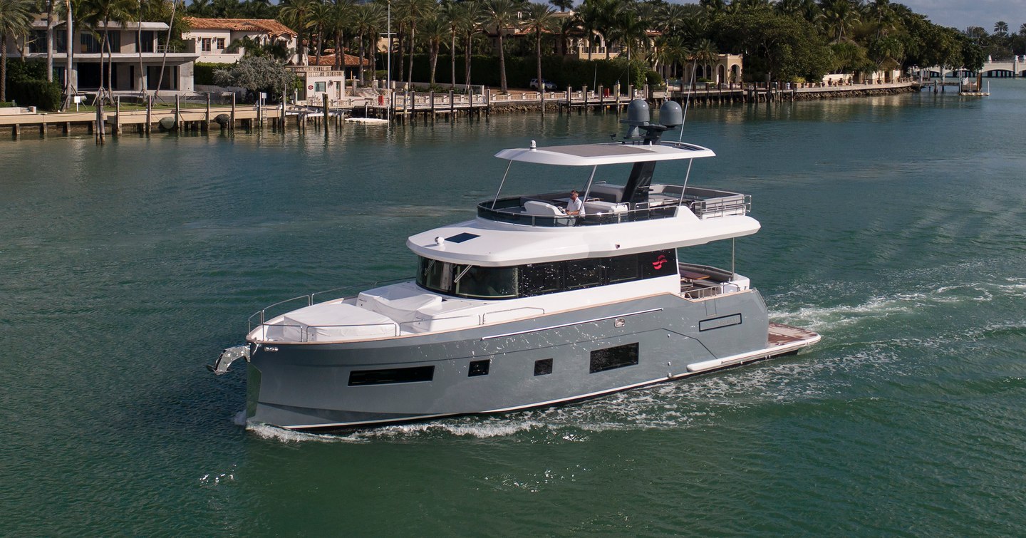 Side view of Sirena 58 underway, passing coastline villas in the US.