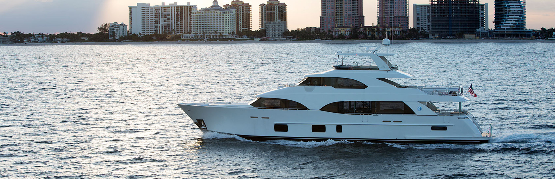 Ocean Alexander yacht on water with skyscraper skyline