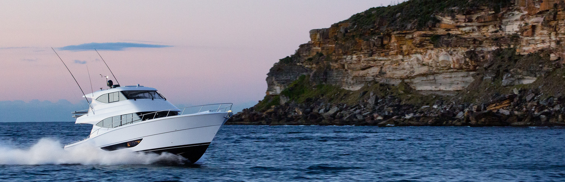 Maritimo yacht with rugged coastline in background