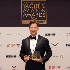 A male award winner in a tuxedo at the International Yacht and Aviation Awards