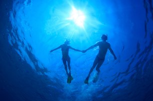 couple diving holding hands