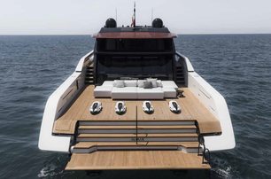 Sanlorenzo SP110 motor yacht aft deck view mid aerial, platform lowered shwing steps to aft deck and forward to seating, smooth sea, fairly bright day