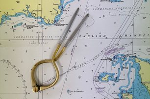 pair of dividers on nautical chart