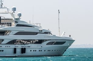 Benetti superyacht SEANNA shown starboard side profile from amidships looking towards the bow, on anchor in moderate sea on bright day