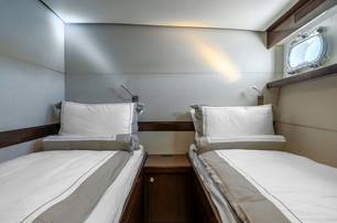 Motor yacht Sultana twin guest cabin with small window