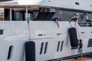 yacht crew working on superyachts cleaning and fenders