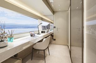 Office desk and chair onboard Arcadia A115, facing wide window overlooking sea