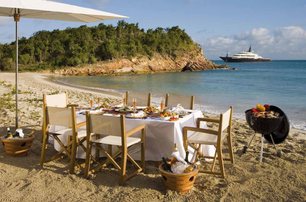 beach picnic set by interior yacht crew with yacht in background