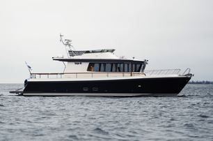 Targa 46 motor boat still in water, shot from water level towards starboard side profile, smooth sea, grey day