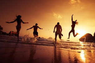 people dancing on beach at night