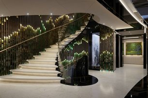 KISMETs grand staircase shown, white marble flooring, and stunning sweeping staircase, elements of tones of green