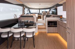 Gulf Craft Majesty 60 interior shot looking over dining area towards helm area