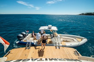 yacht crew assisting guests into yacht tender