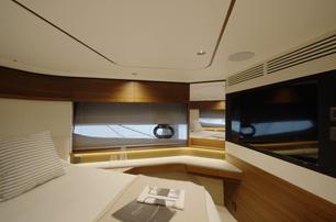 Princess S65 Mk2 VIP cabin with wall-mounted television and walnut cabinetry