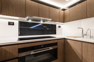 AB Yachts AB 80 motor yacht galley with warm wood interior 