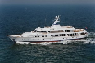 Feadship classic yacht LADY BEATRICE for sale at 2024 Monaco Yacht Show shown in running shot aerial view over port side, smooth sea