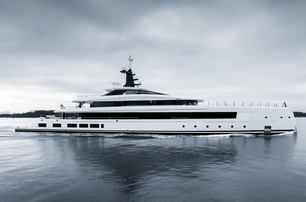 Lurssen yacht HAVEN making way slowly in calm waters on grey day, starboard side profile, water level