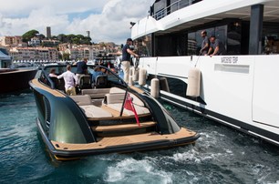 tickets and access to Cannes Yachting Festival image shows a luxury tender departing dock by side of superyacht