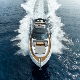 75 Sport Yacht mid aerial view of yacht bow, head on, wake indicates yacht moving at speed in calm waters