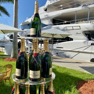 moet champagne stacked on display with yachts in background