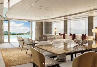 glossy dining table surrounded by chairs forward of a cream lounge area in the main salon of the Amels 60 yacht