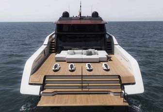 Sanlorenzo SP110 motor yacht aft deck view mid aerial, platform lowered shwing steps to aft deck and forward to seating, smooth sea, fairly bright day