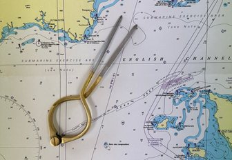 pair of dividers on nautical chart