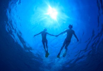 couple diving holding hands