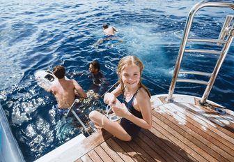 family fun swimming off back of boat