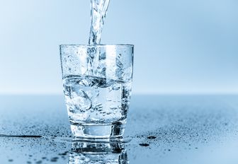 fresh drinking water into glass