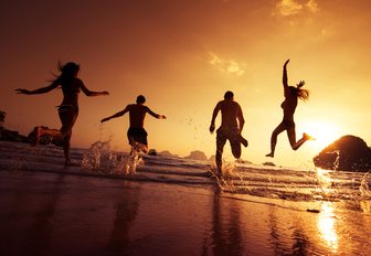 people dancing on beach at night