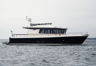 Targa 46 motor boat still in water, shot from water level towards starboard side profile, smooth sea, grey day