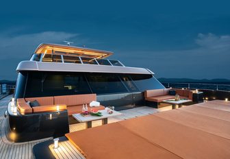 100 Sunreef Power night time shot of bow seating area, with gentle illumination