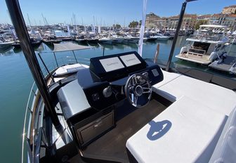 Sessa Marine F60 Flybridge helm station on flybridge shown, yachts in background