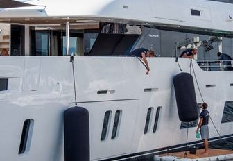 yacht crew working on superyachts cleaning and fenders