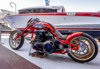 red motorbike with white and red yacht Monaco Yacht Show