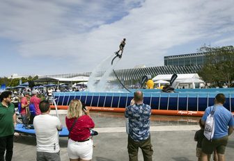 A flyboarding demonstration in action with spectators in the foreground