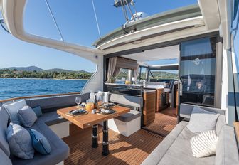 Marex 440 exterior cockpit on bright day, looking towards interior, boat is very open and inviting