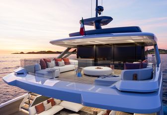 X100 Triplex by EXTRA Yachts  upper deck aft shown at sunset with seating, looking from starboard quarter almost diagonally across the deck forward