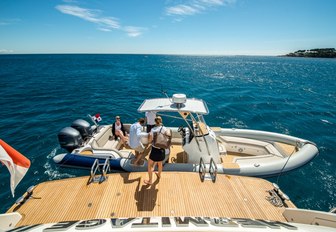 yacht crew assisting guests into yacht tender