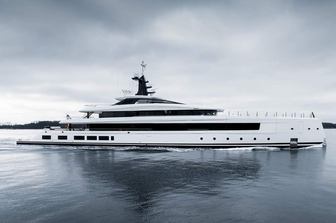 Lurssen yacht HAVEN making way slowly in calm waters on grey day, starboard side profile, water level